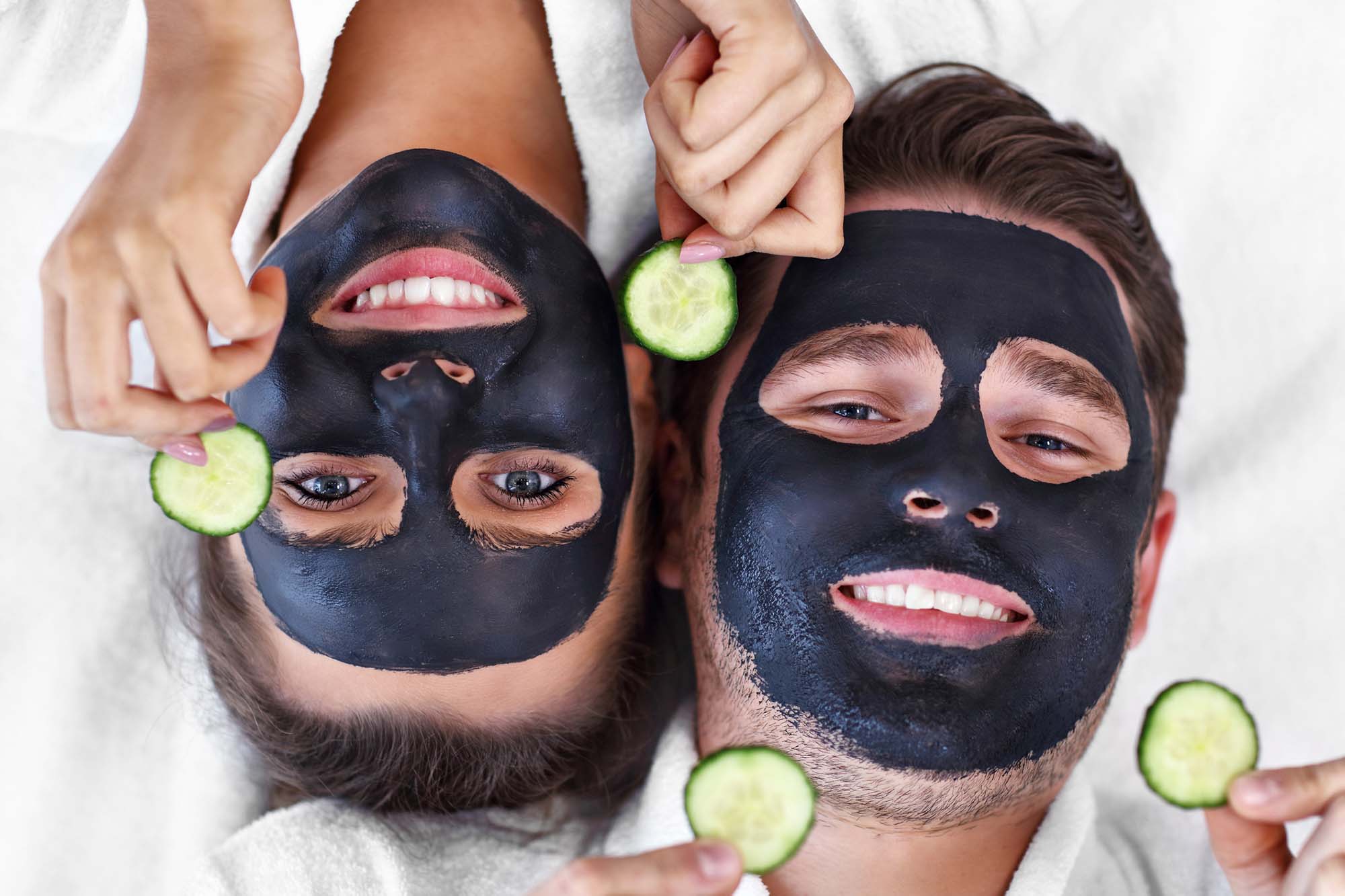 Happy couple having facial in spa salon Happy couple having facial in spa salon