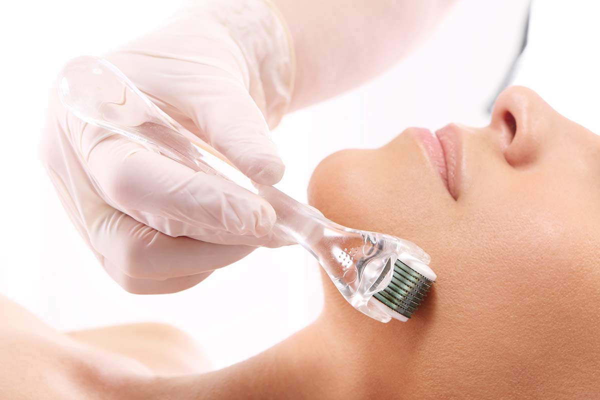 Beautician performs a needle mesotherapy treatment on a woman's face