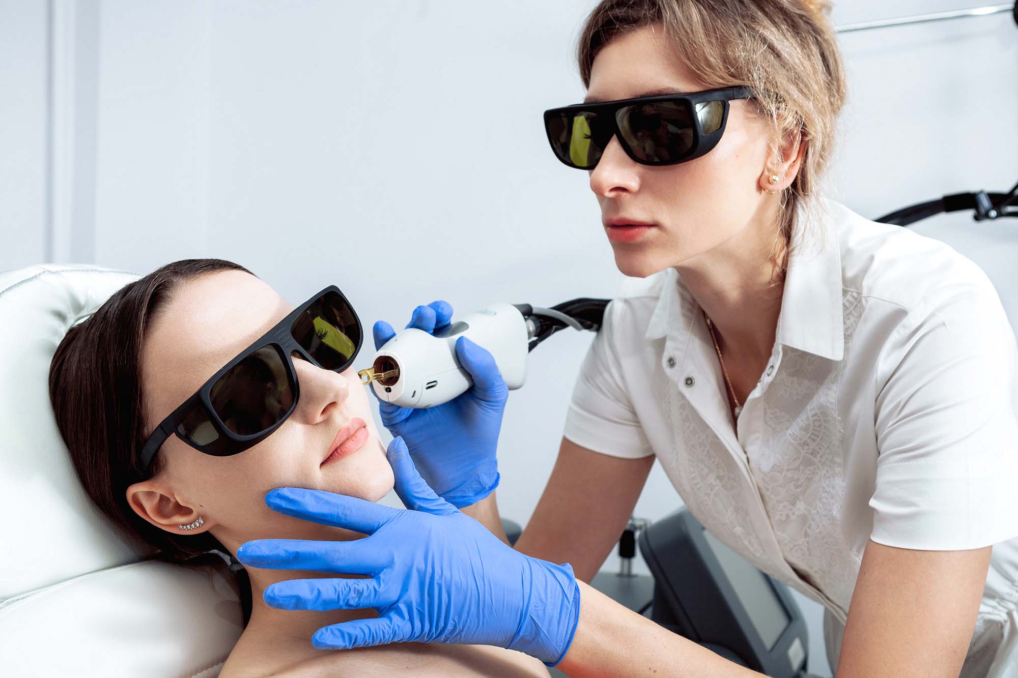 Skin Care. Young Woman Receiving Facial Beauty Treatment, Removing Pigmentation At Cosmetic Clinic. Intense Pulsed Light Therapy. IPL. Rejuvenation, Photo Facial Therapy. Anti-aging Procedures. Skin Care. Young Woman Receiving Facial Beauty Treatment, Removing Pigmentation At Cosmetic Clinic. Intense Pulsed Light Therapy. IPL. Rejuvenation, Photo Facial Therapy. Anti-aging Procedures.