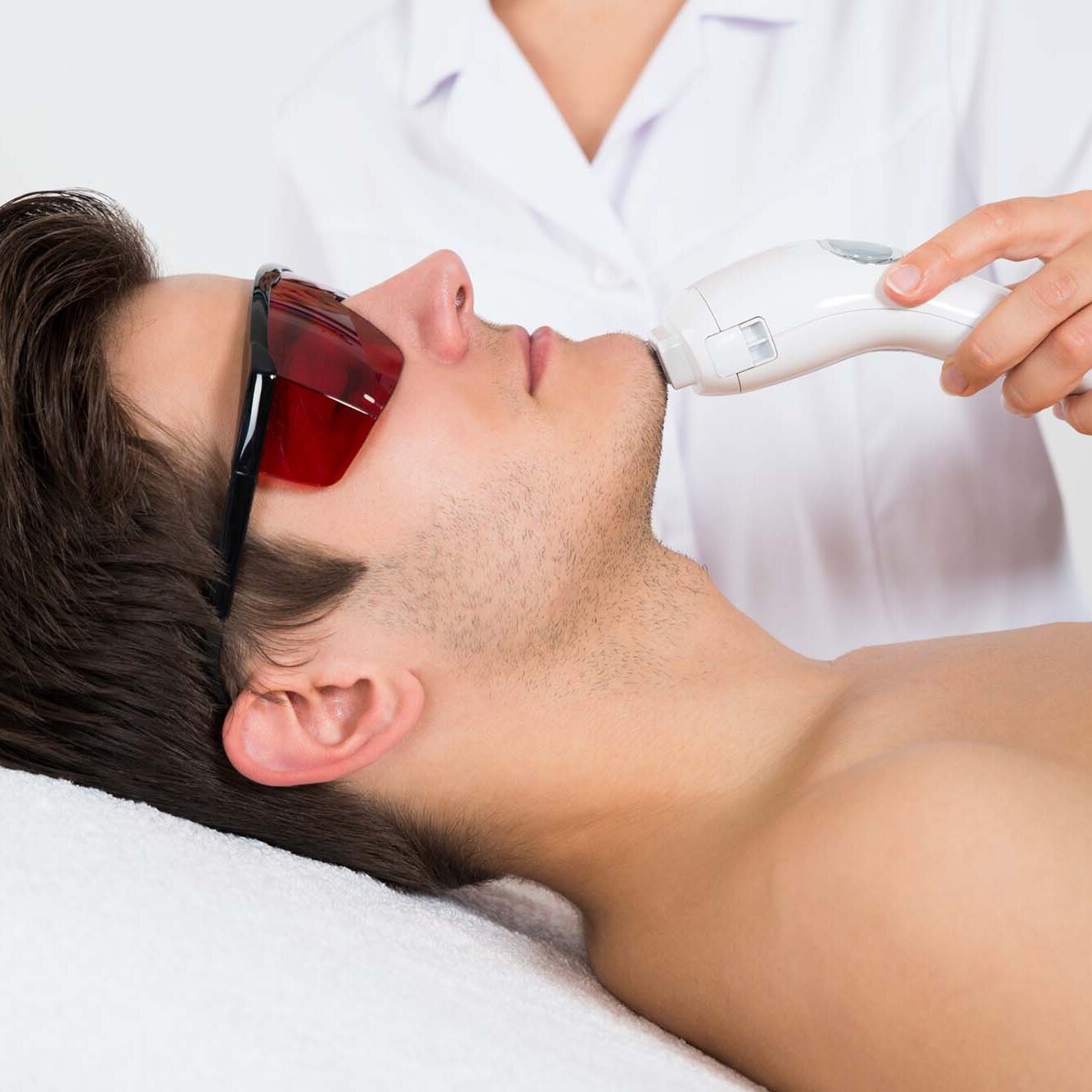 Man Receiving Laser Hair Removal Treatment Man Receiving Laser Hair Removal Treatment