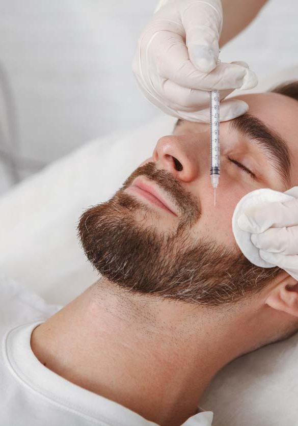 Handsome man getting facial skincare treatment at salon