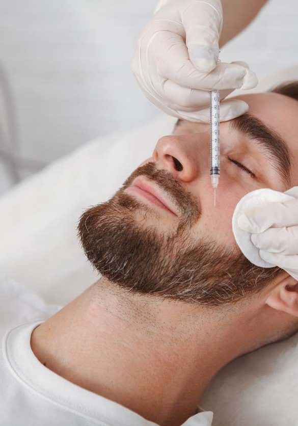 Handsome man getting facial skincare treatment at salon Handsome man getting facial skincare treatment at salon