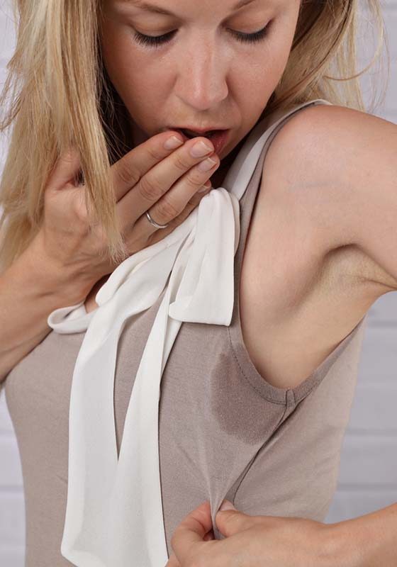 Business woman armpit sweating. Transpiration stain. Hyperthyroidism concept